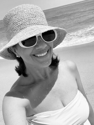 Desiree-Leone-Beautifully-Seaside-on-Nantucket-wearing-raffia-bucket-hat-and-one-piece-swimsuit-1