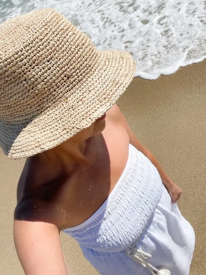 Desiree-Leone-of-Beautifully-Seaside-in-Nantucket-wearing-J.Crew-linen-coverup-dress-and-raffia-bucket-hat-768x1024