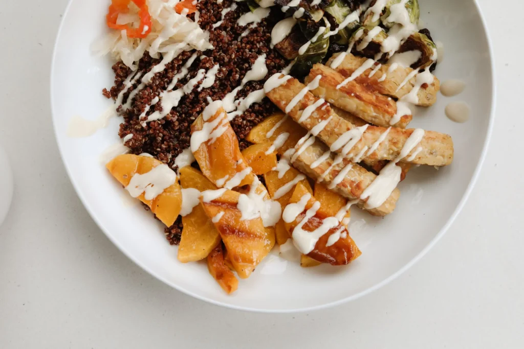 Colorful grain bowl with quinoa, roasted vegetables and tofu