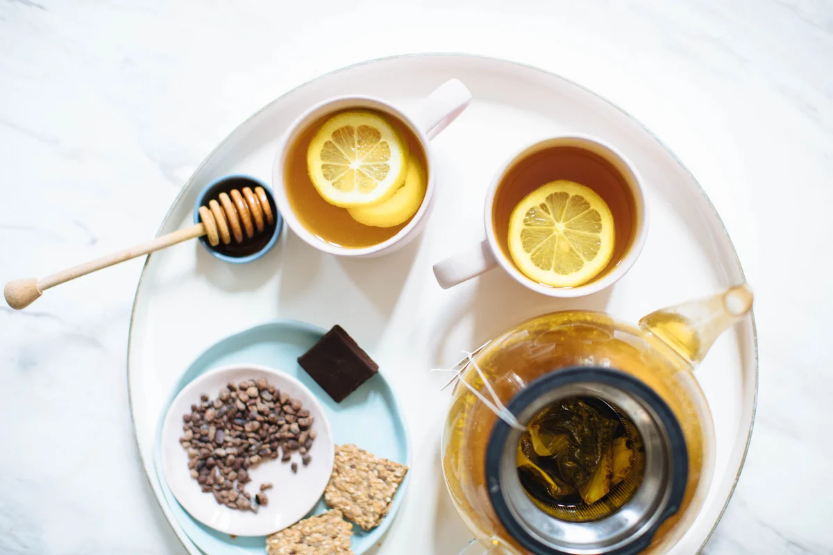 Tea set with herbal tea, nuts and crackers for mindful evening snacking