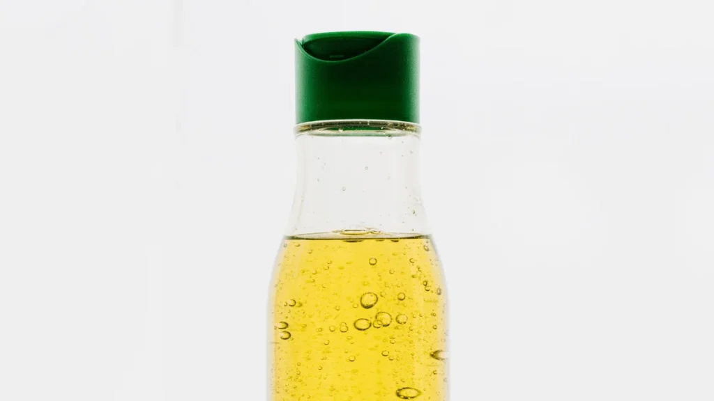 Colorful array of cooking oil bottles on kitchen counter