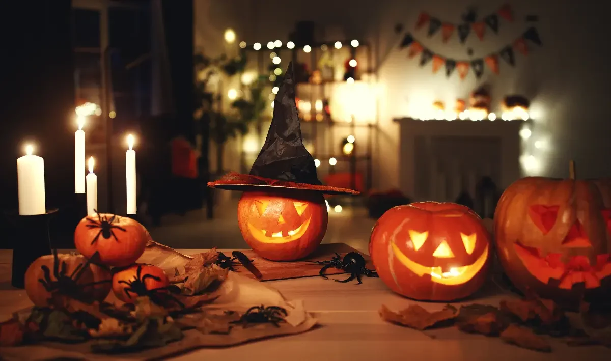 glowing jack-o-lanterns and candles in a cozy decorated room