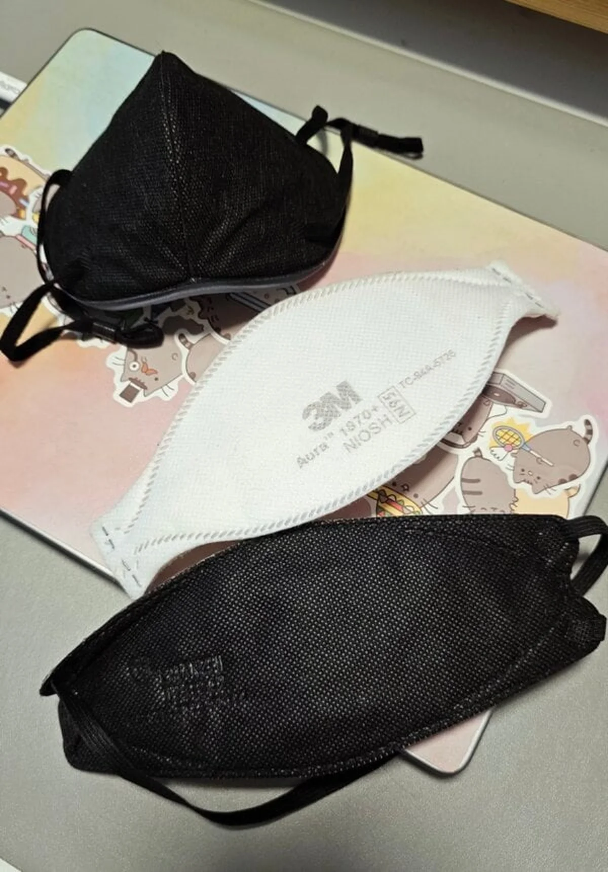 Three respirator mask models lined up for visual comparison