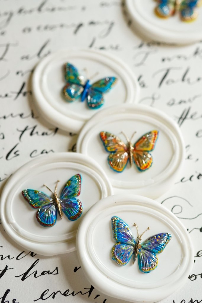Delicate light-colored handcrafted butterfly wax seal stamp design