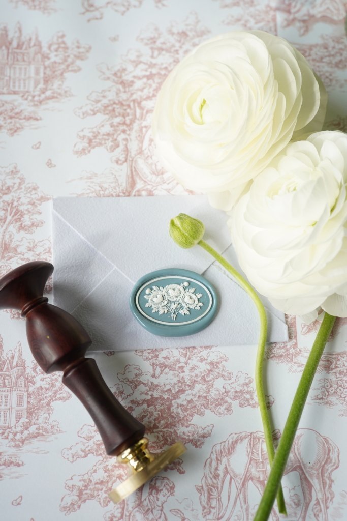 Colorful hand-torn ranunculus flower wax seal design