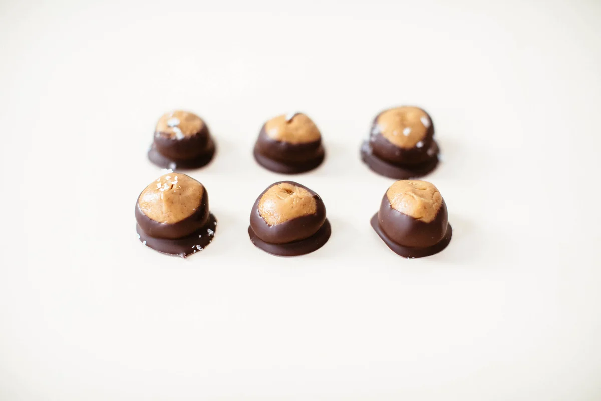 Chocolate-covered peanut butter buckeye holiday treats on plate