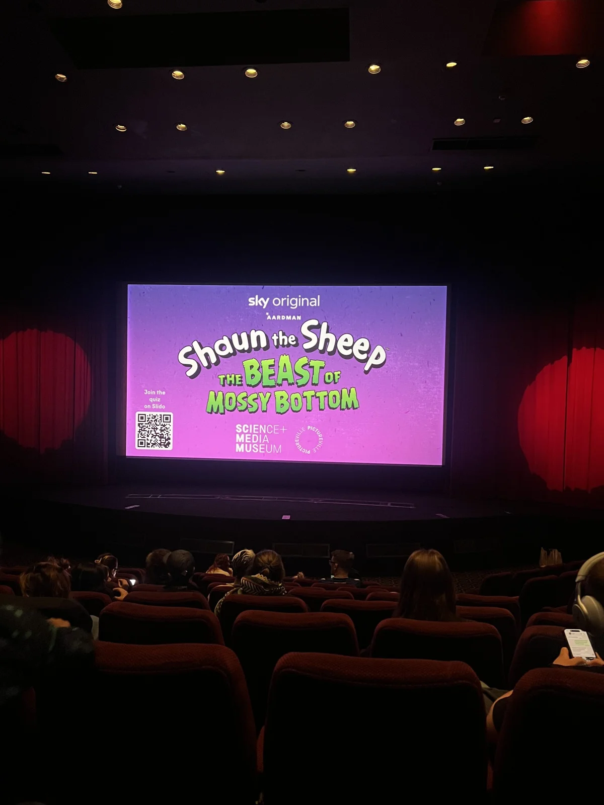 Cinema audience watching the new Shaun of the Sheep film on screen