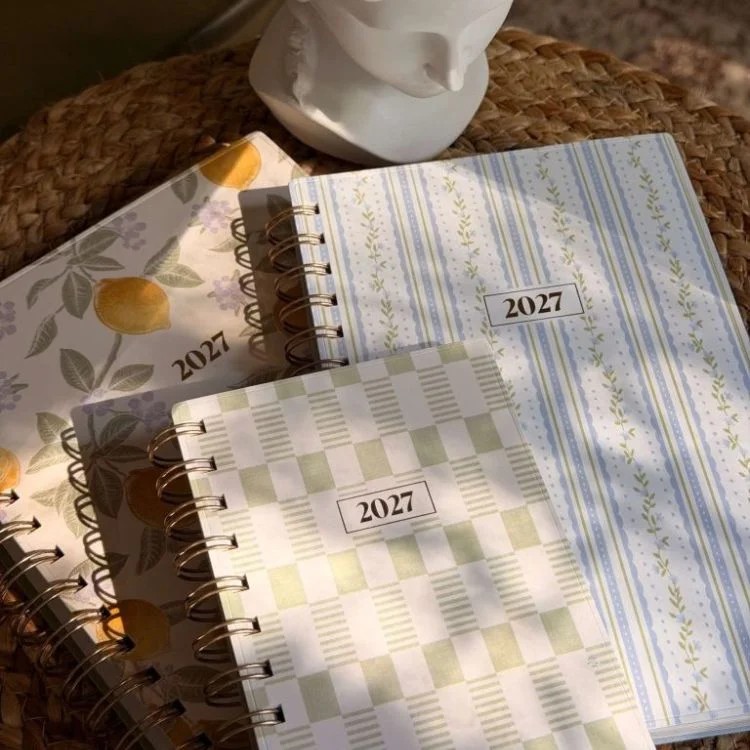Spiral-bound weekly and monthly planners in soft colorways